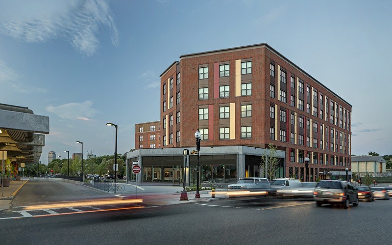 a building on the corner of a busy city street with cars